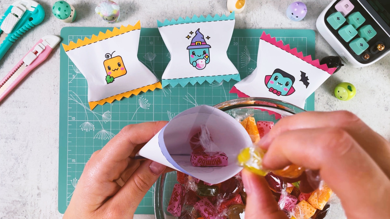 Dropping wrapped candies from a glass bowl into the open paper bag