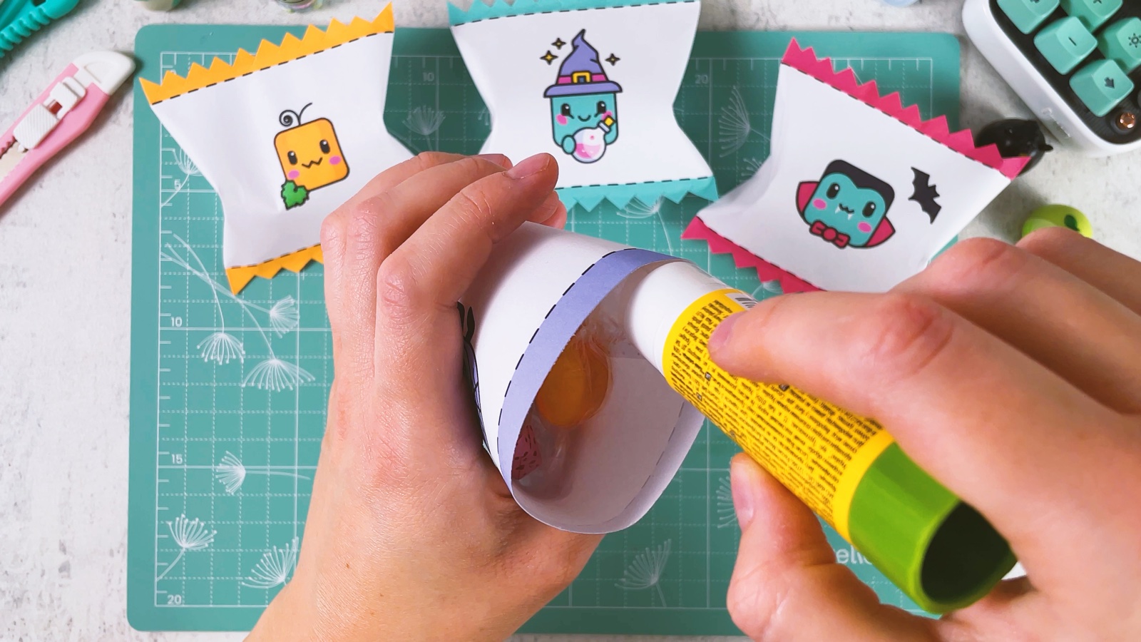 Putting glue inside the top band of the bag, with candies already inside