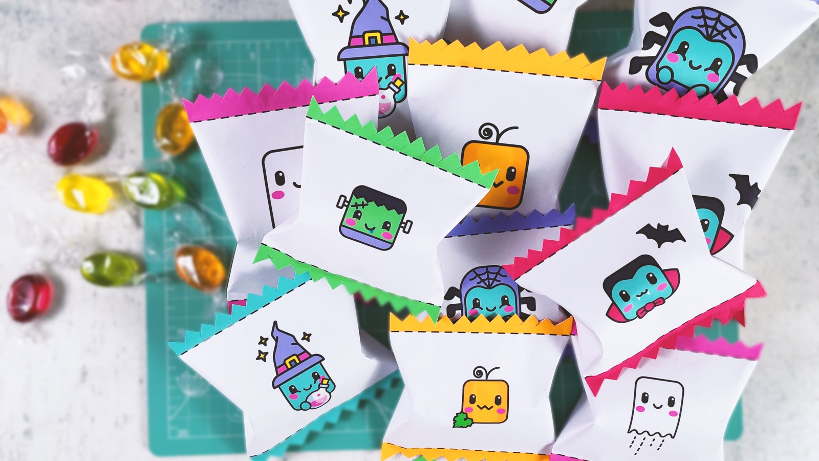 A pile of finished paper Halloween candy bags with zigzag ends