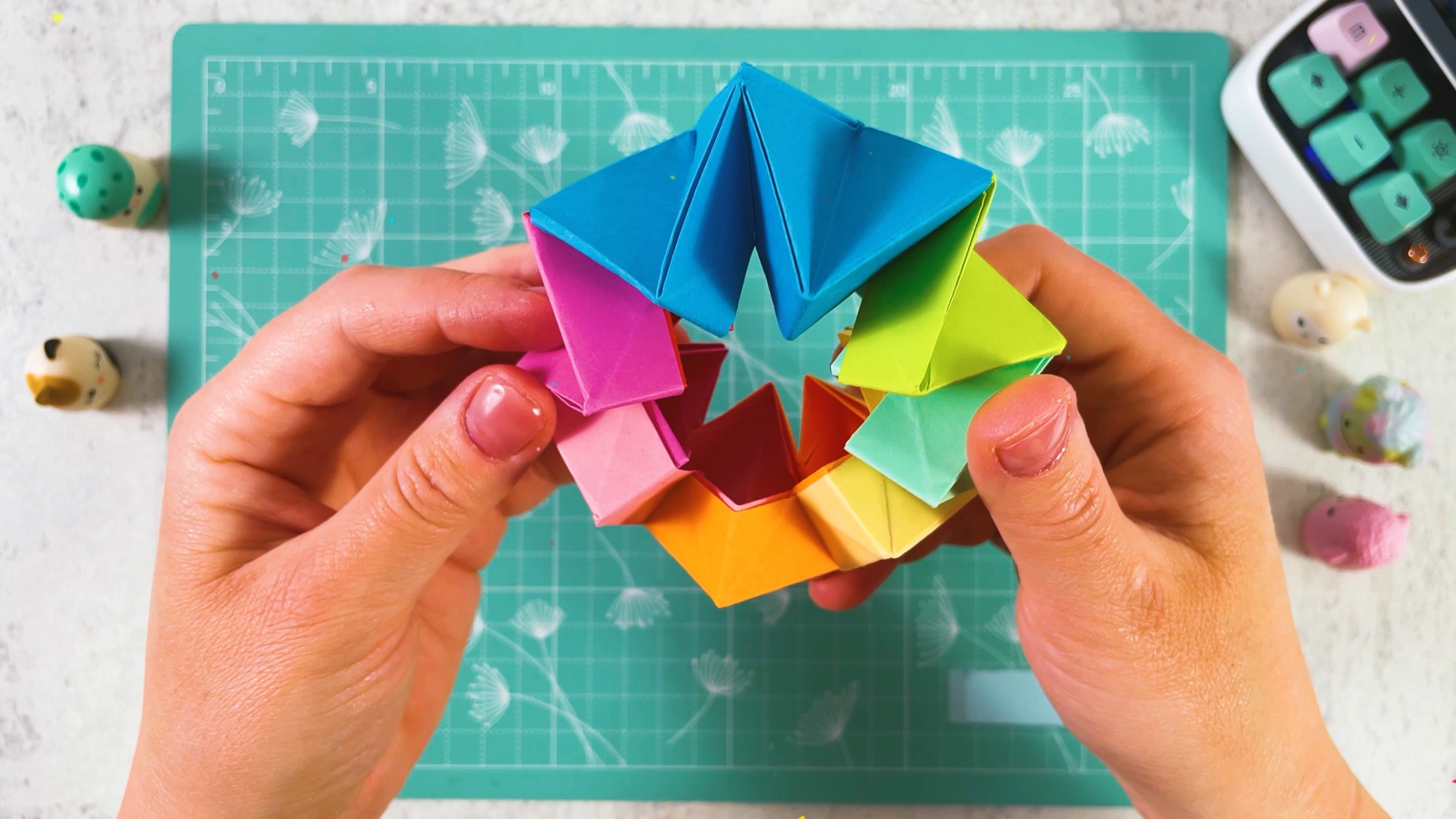 The rainbow paper toy held as a round ring with a star-shaped hole in the middle