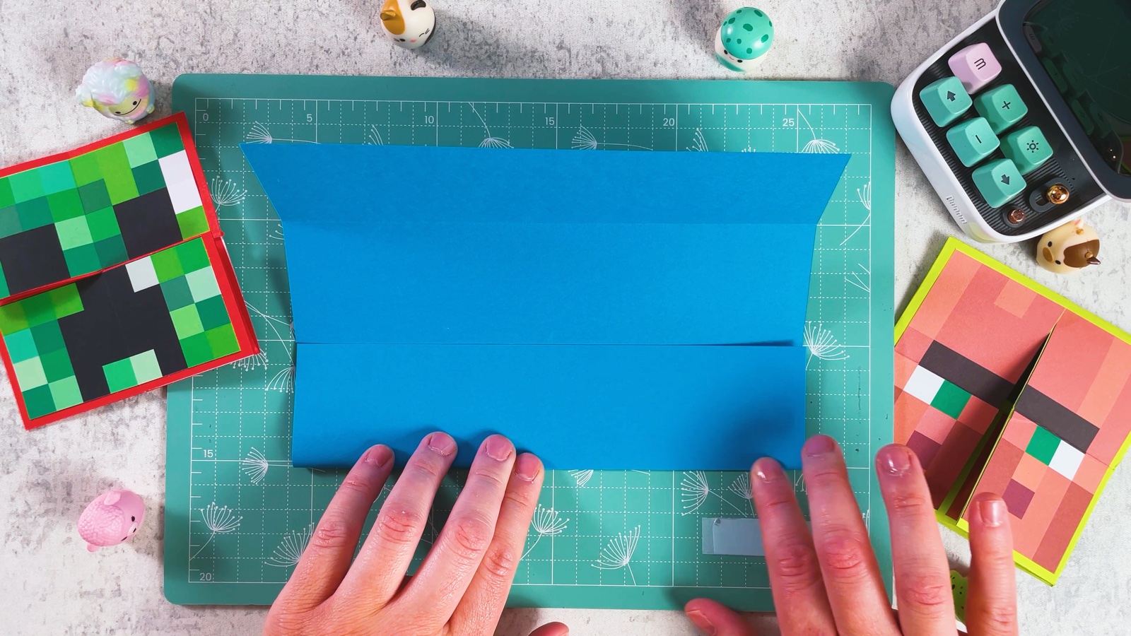 Folding the top and bottom edges of the blue square to the middle line