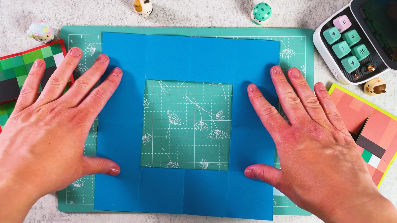 The opened blue paper: a square frame with the middle cut out