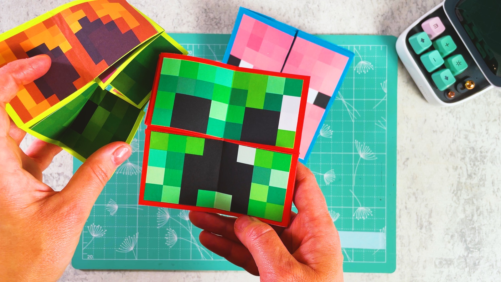A finished Minecraft paper flip toy showing the Creeper face