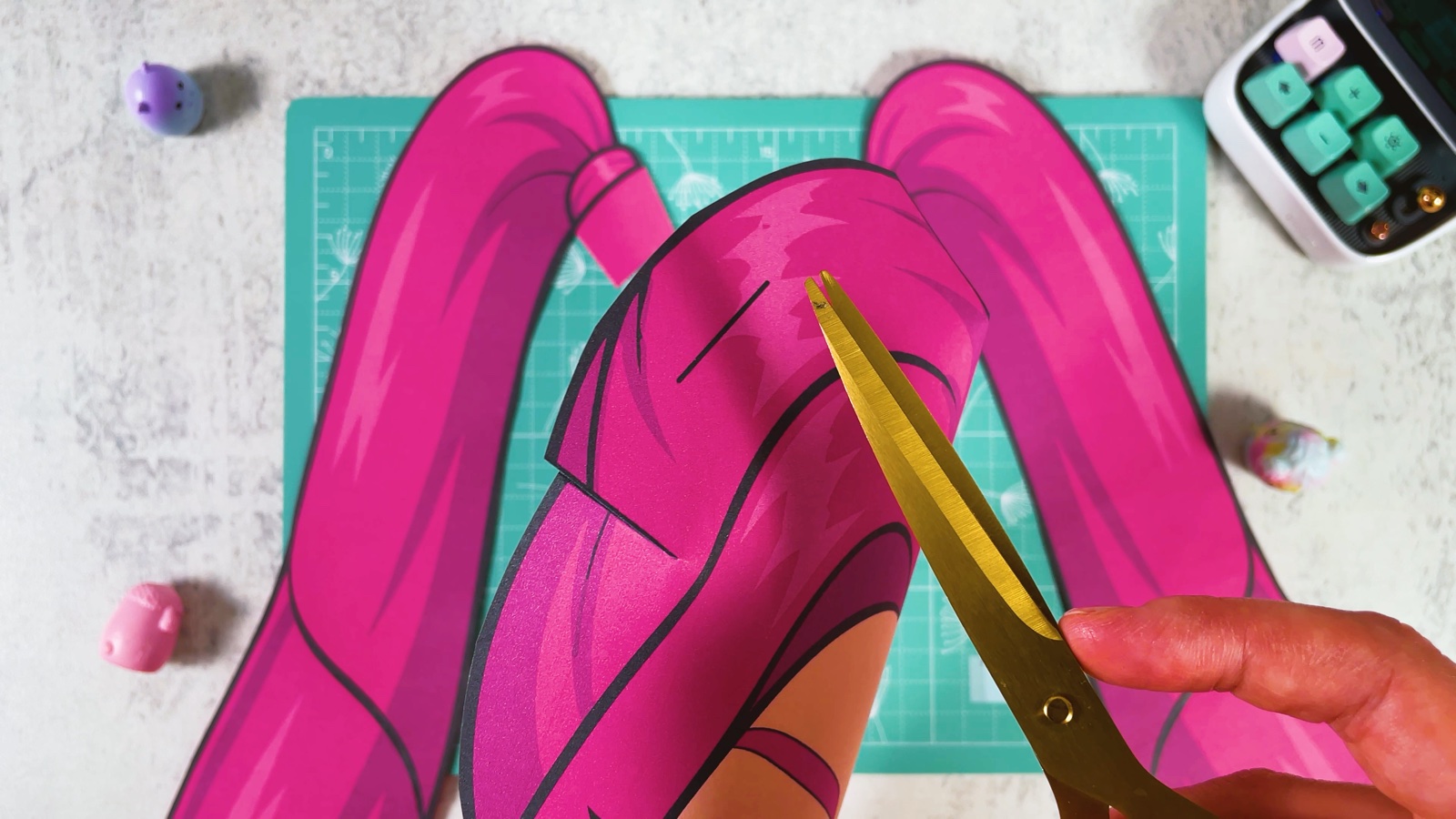 Cutting along the short black line in the hair at the top of the mask