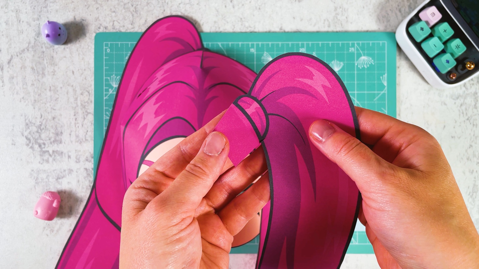 Pushing the ponytail tab into the slit in the hair