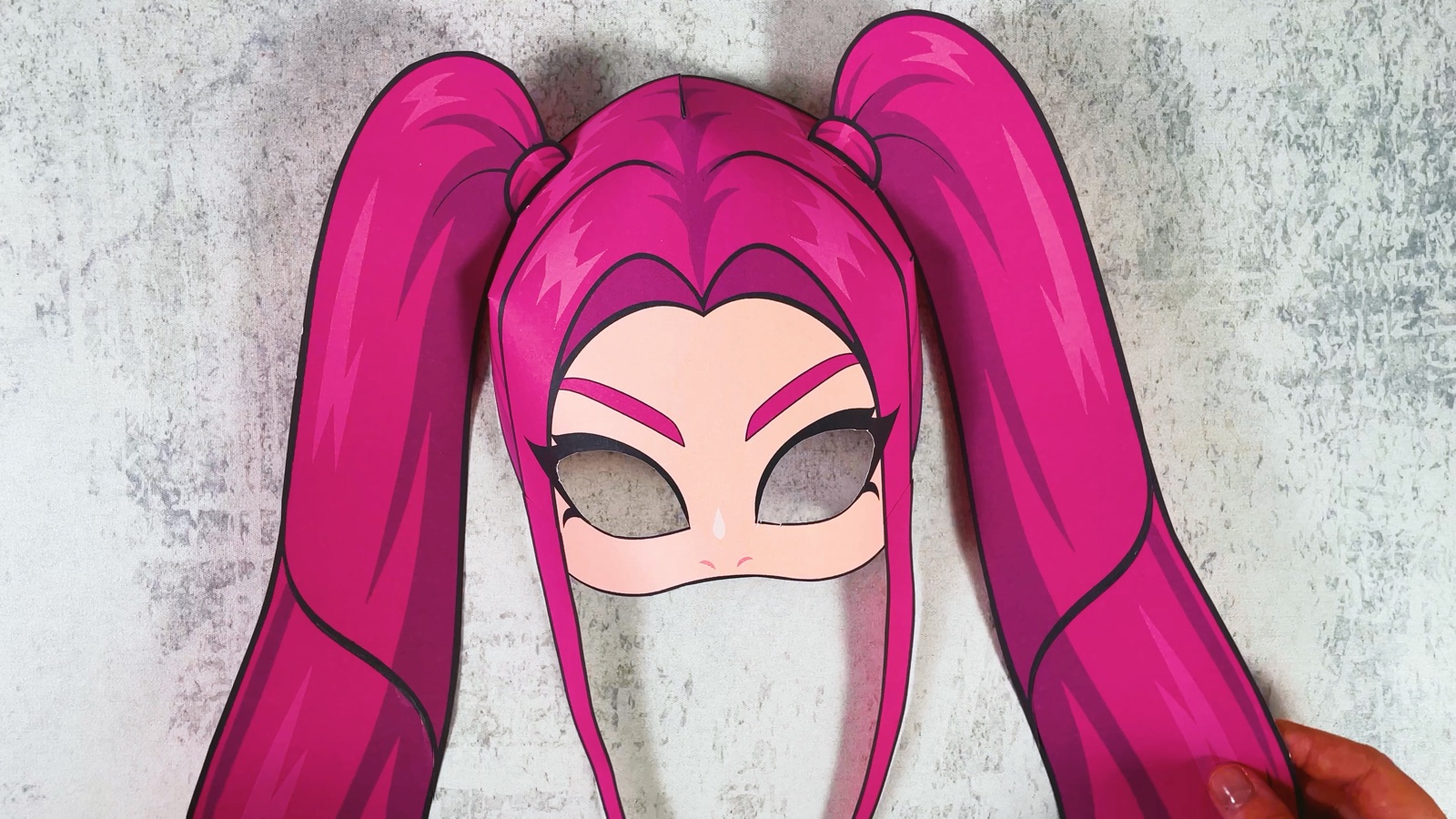 The finished paper Mira mask with pink hair, two long ponytails and two front strands