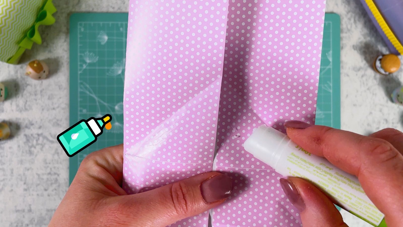 Gluing the two folded sides together with a glue stick