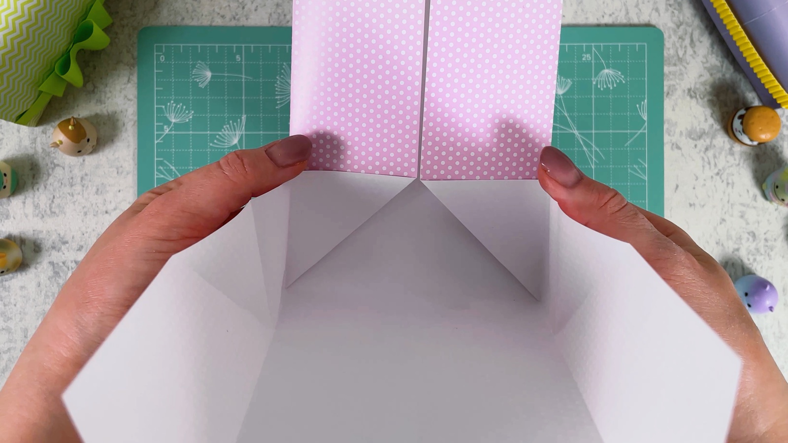 The glued sides meeting in the middle, with the white inside opening up below