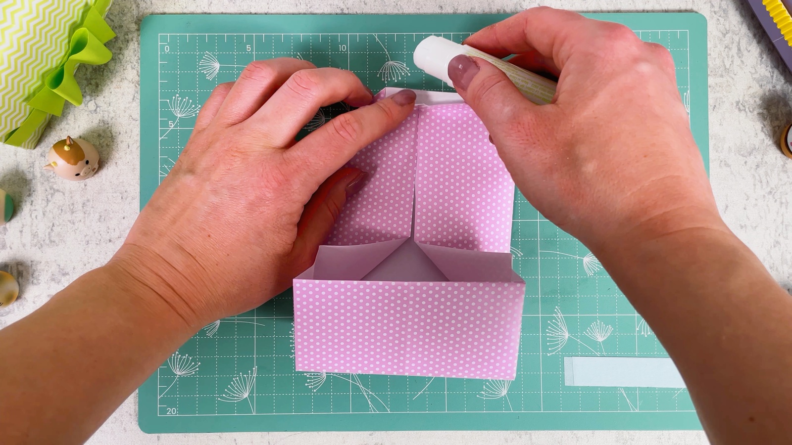 Gluing under the folded corners at the top of the flap
