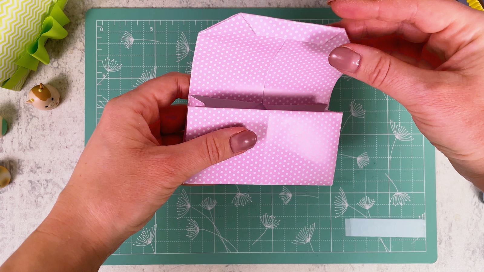 Folding the flap down over the front of the purse
