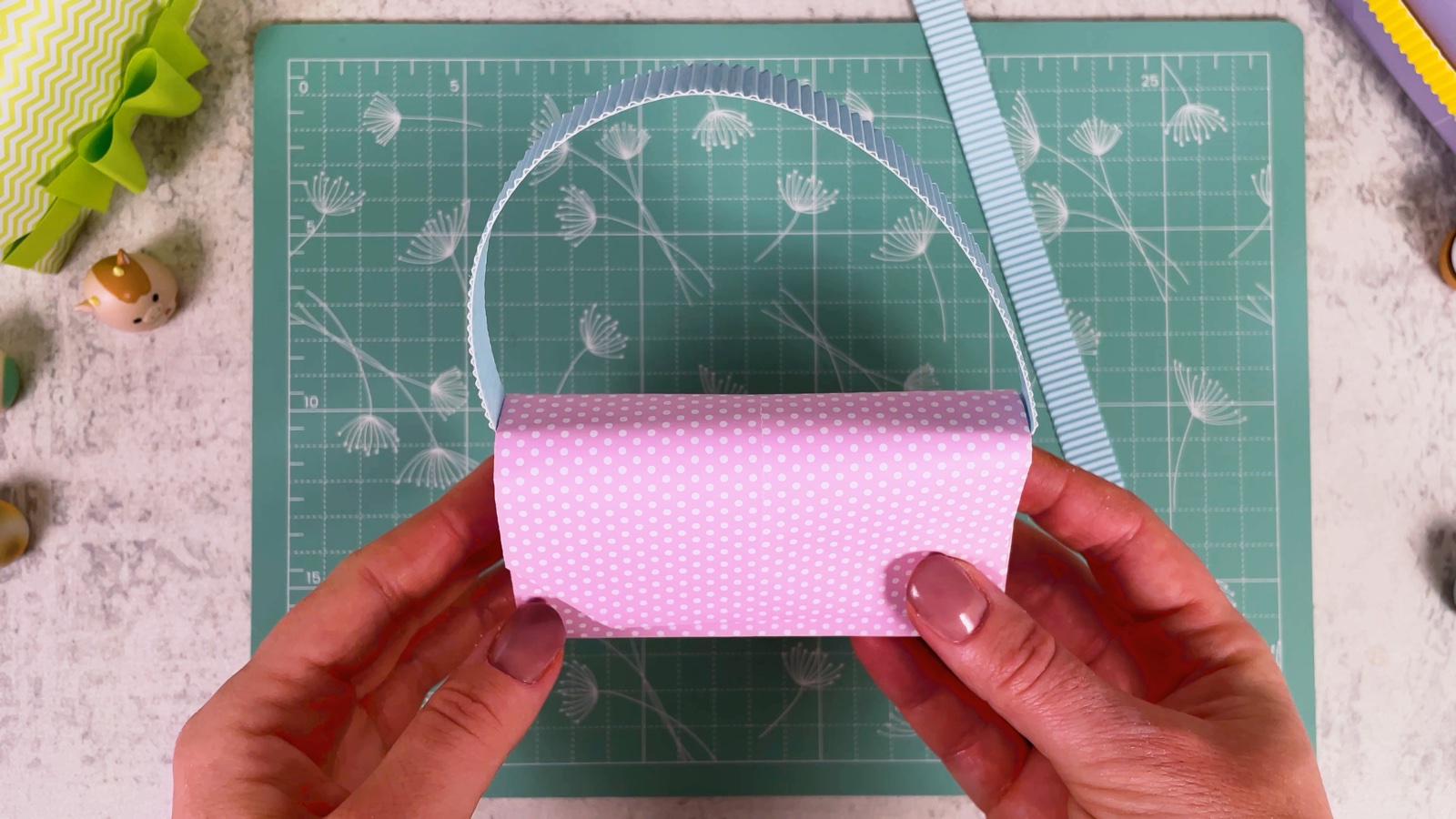The purse with a blue corrugated handle attached at both sides
