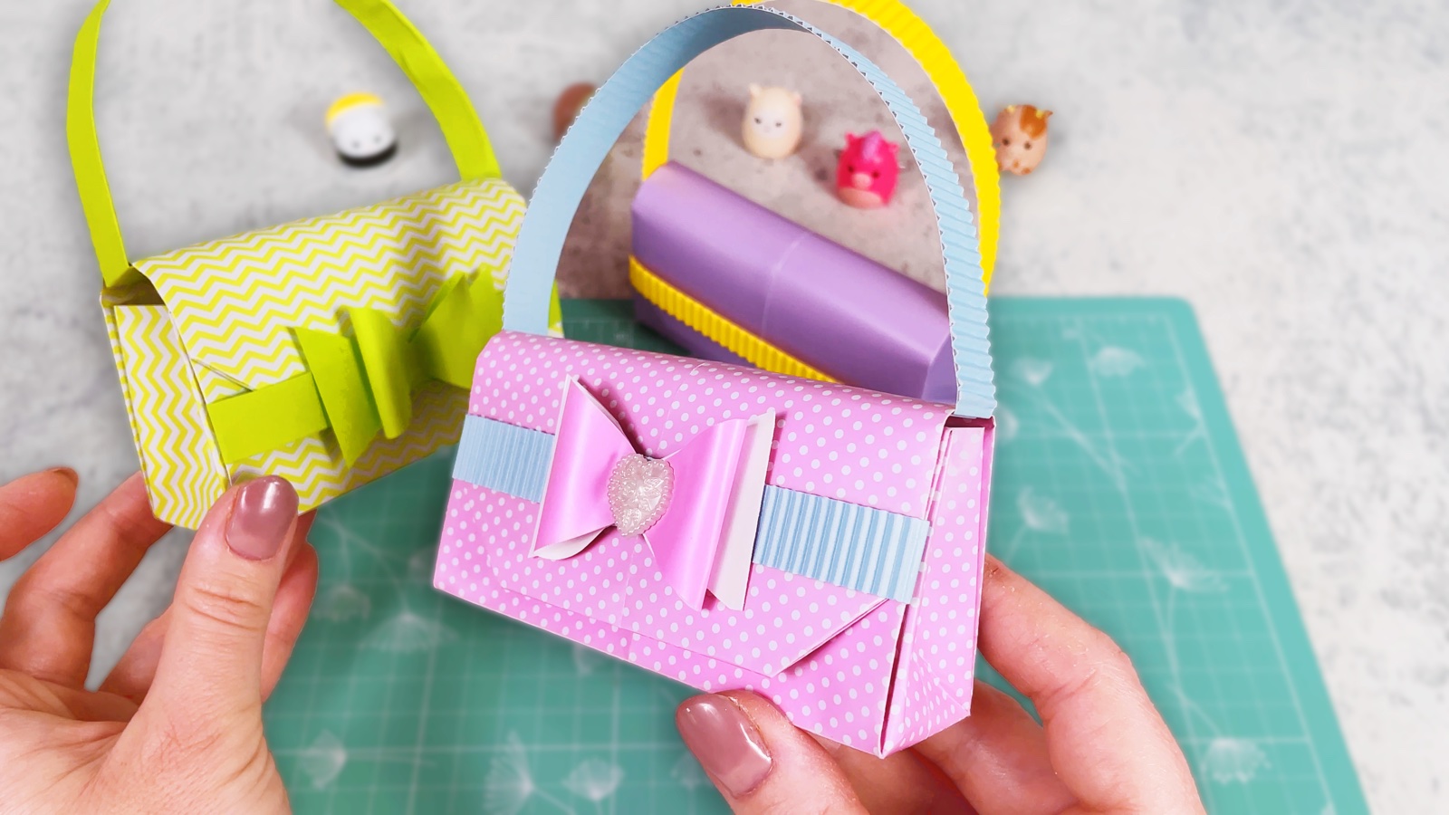 Finished pink polka dot paper purse with a blue handle and a pink bow