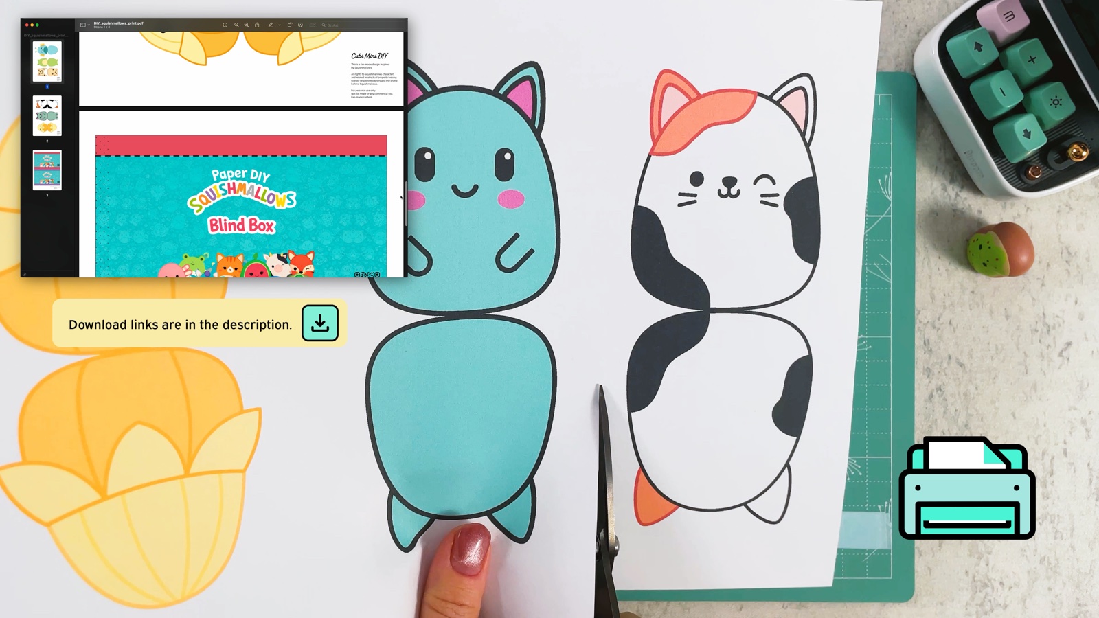 Las plantillas de squishies impresas junto a la impresora, con las figuras del gato calicó y del gato color menta
