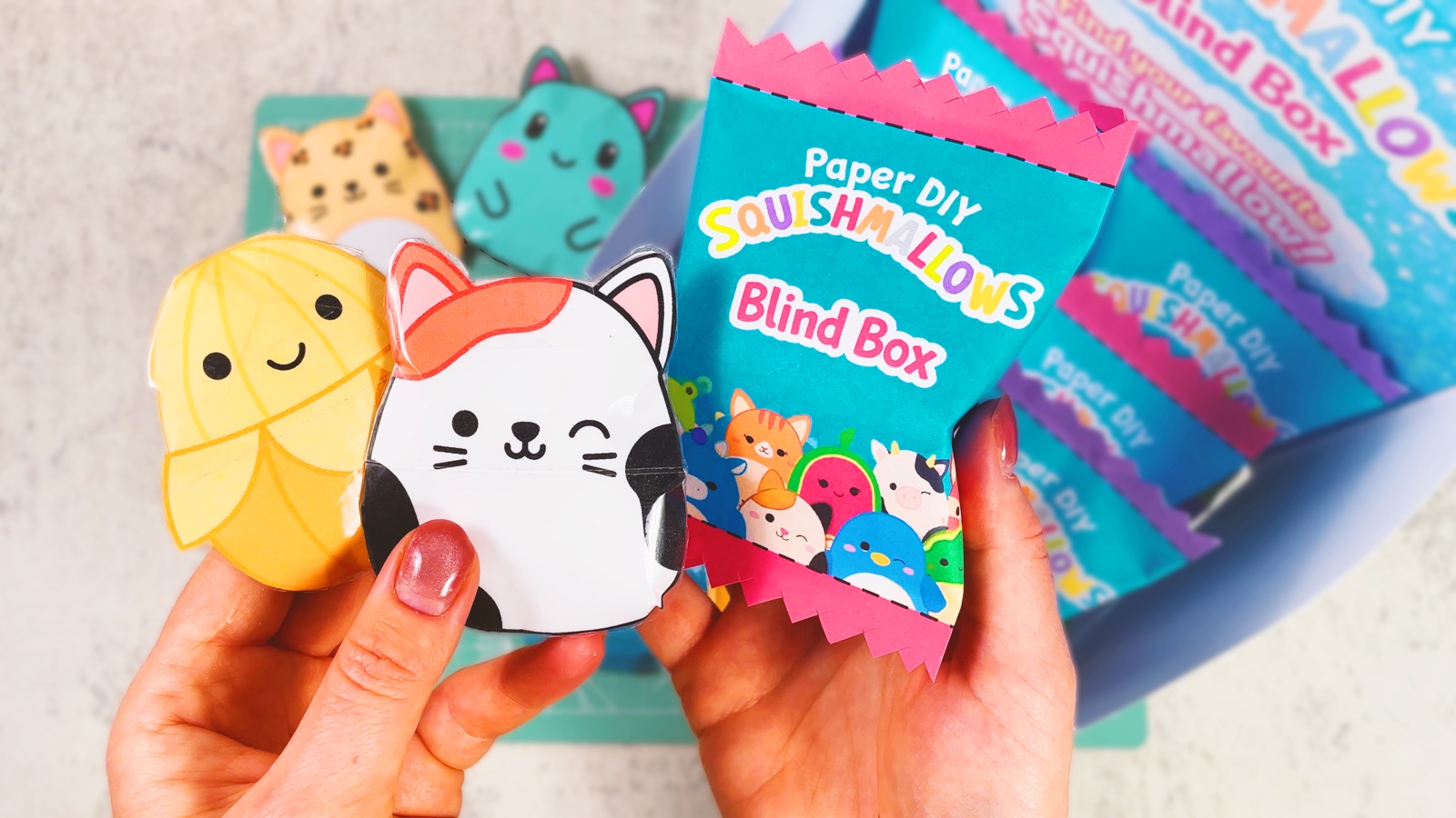 Three finished paper squishmallows next to their paper blind box