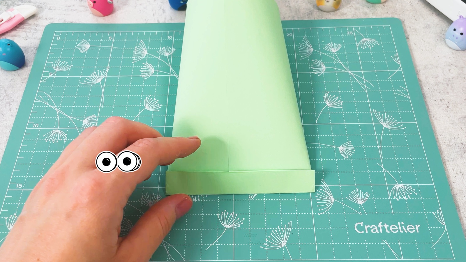 The bottom edge of the green tube folded up into a narrow strip