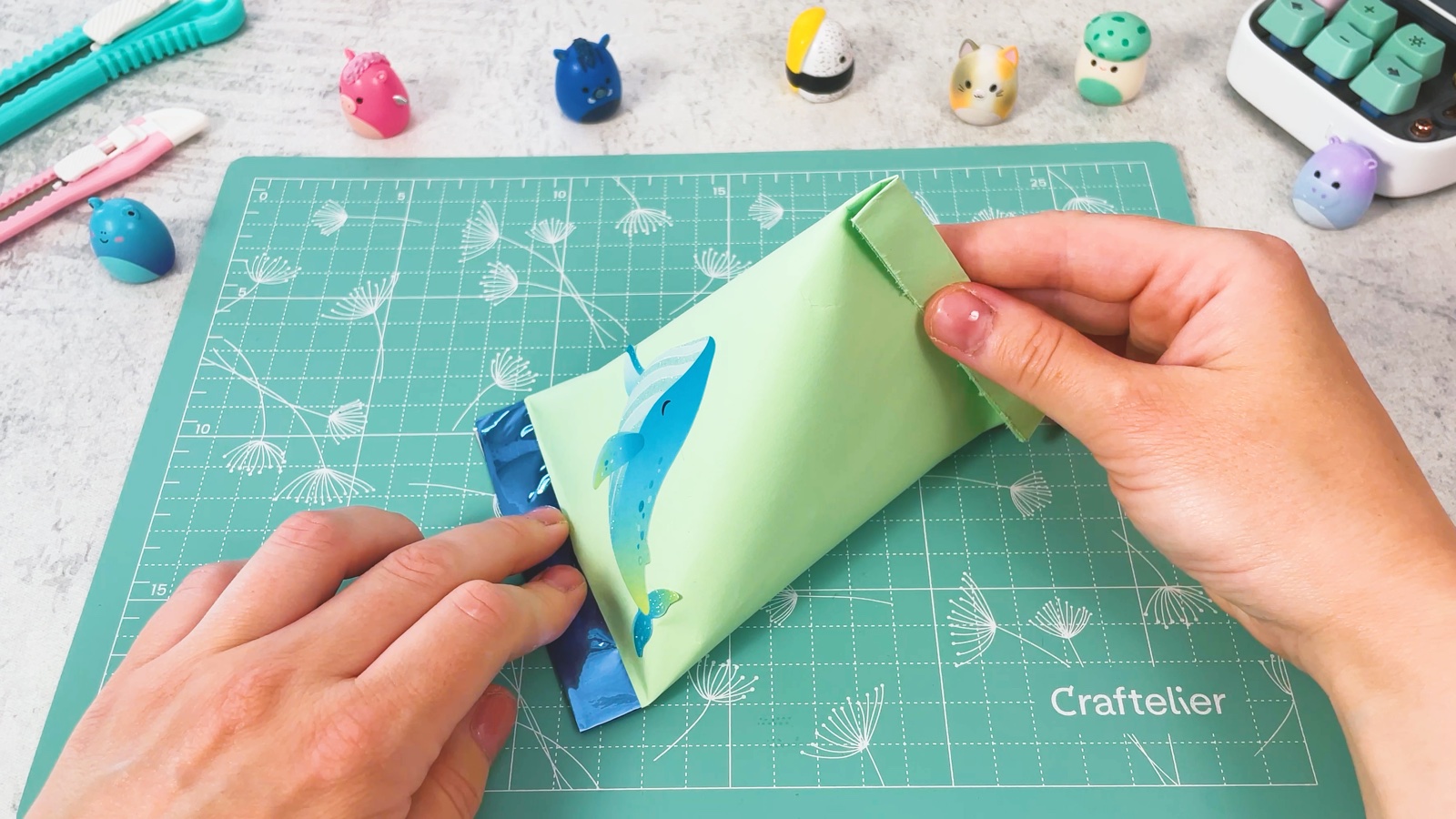 Folding the top edge of the filled bag down to close it