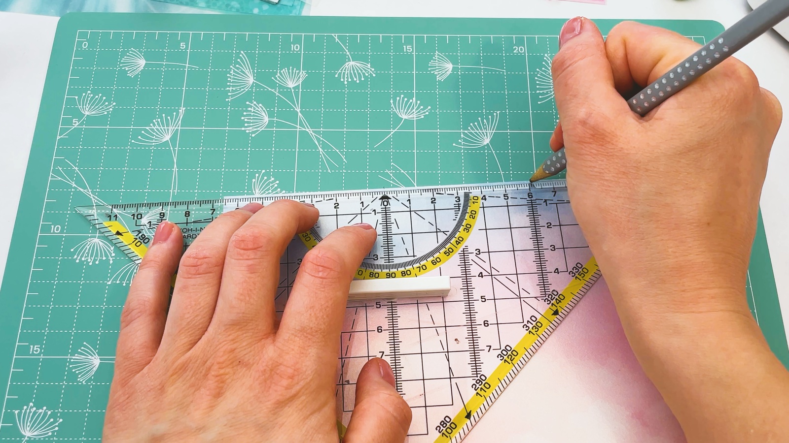 Making a small pencil mark at the edge of the paper along a set square