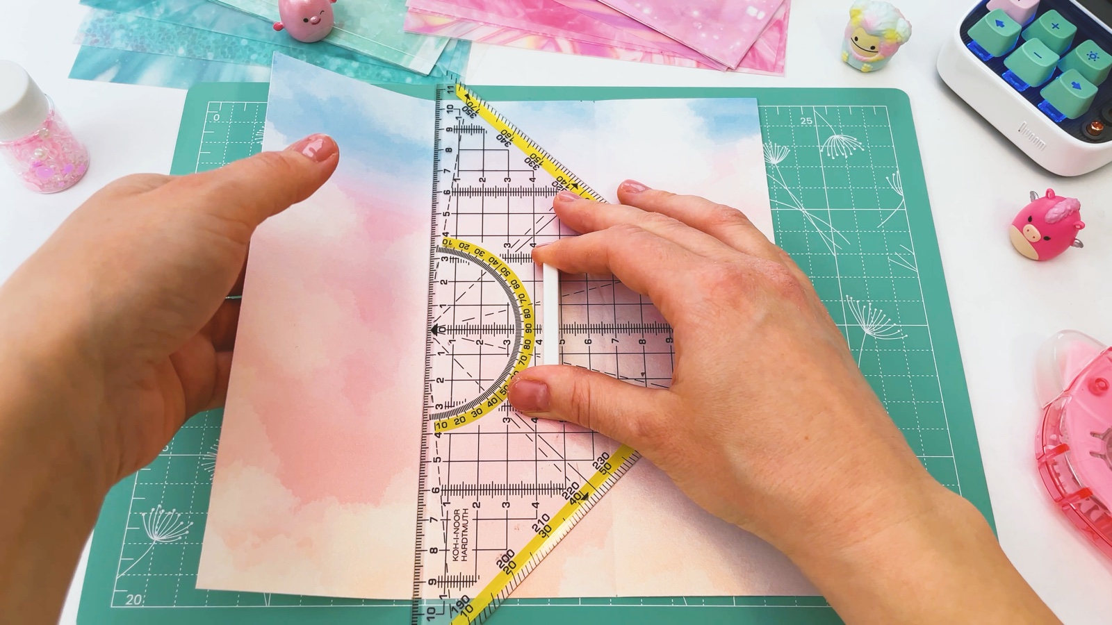 Folding the side of the paper up over the edge of a set square