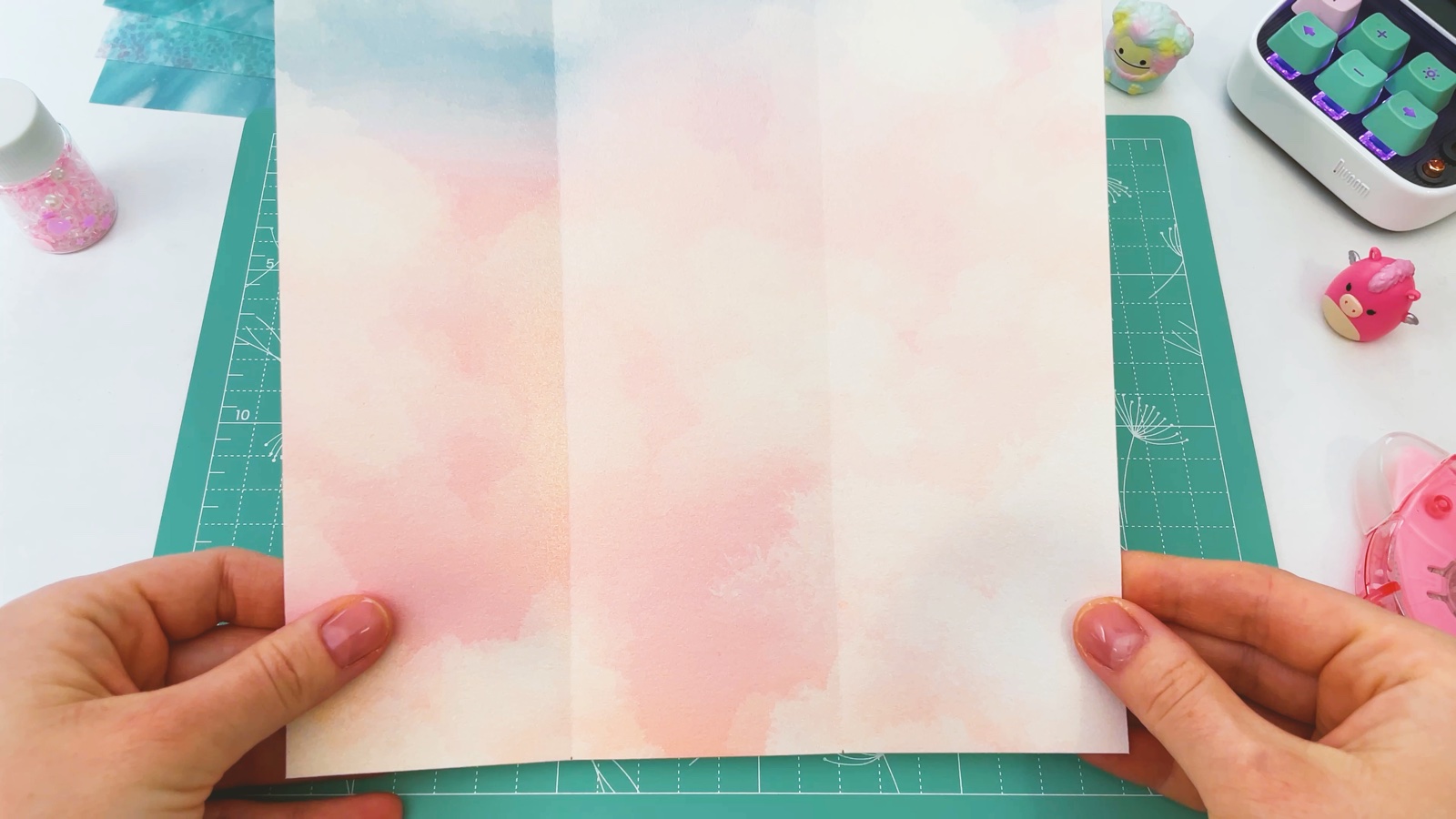 The opened paper with two creases that split it into three strips