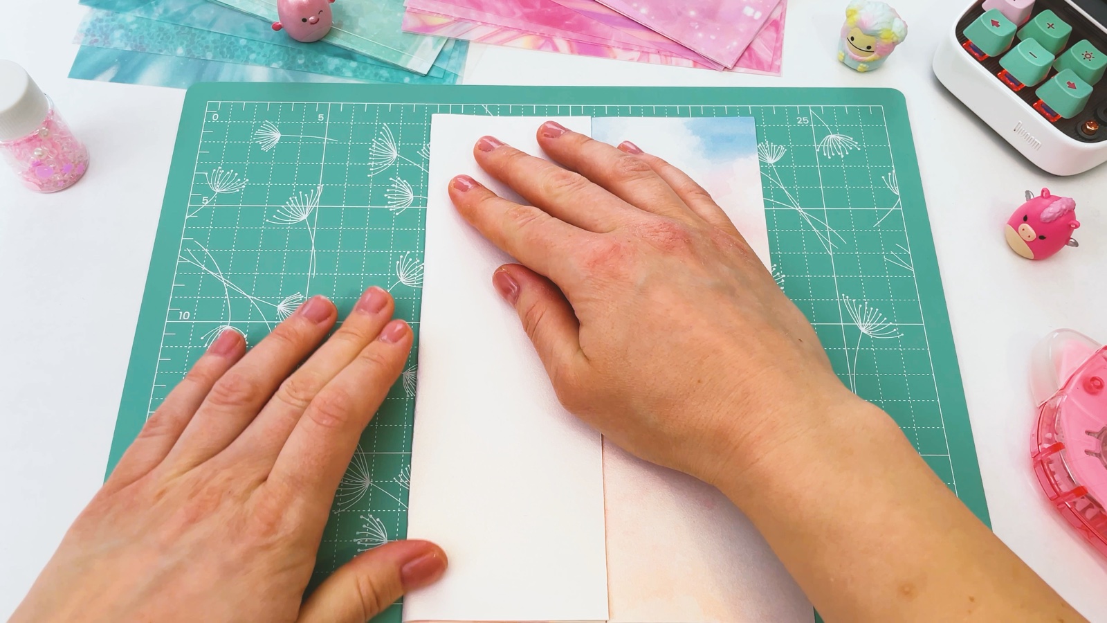 Pressing a folded side of the paper flat, with the white back of the paper on top