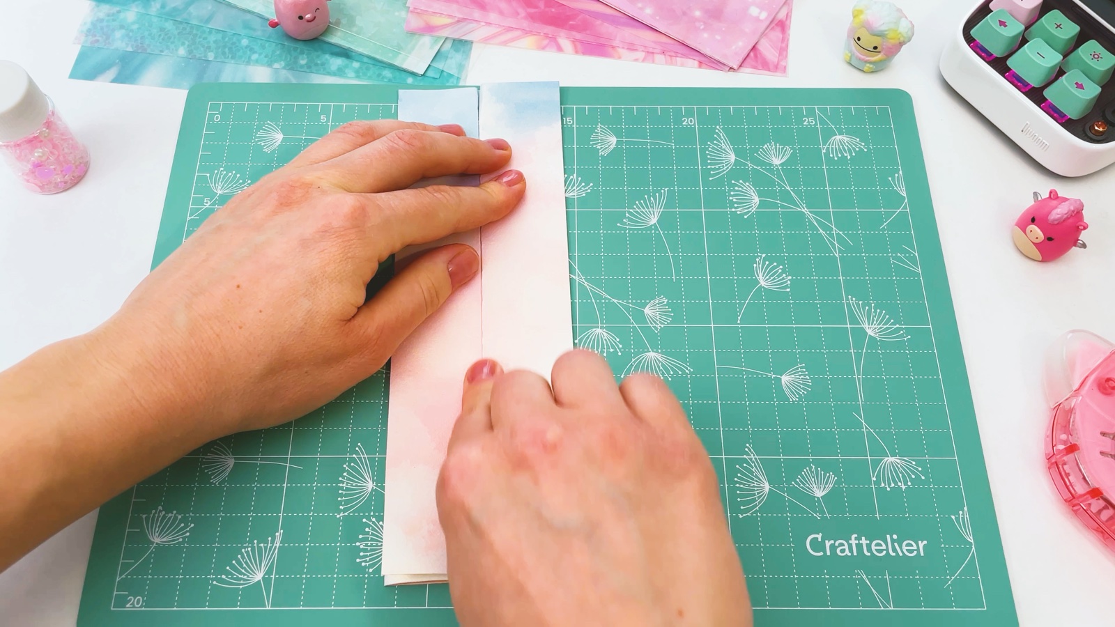 Pressing the paper folded into a narrow strip on the cutting mat