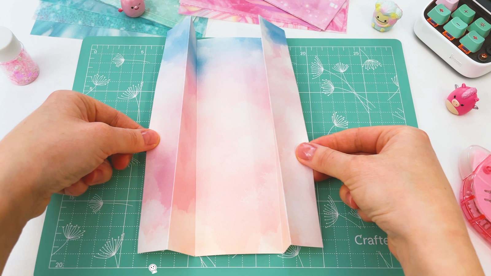 The paper opened out again, with the narrow side strips standing up along the creases