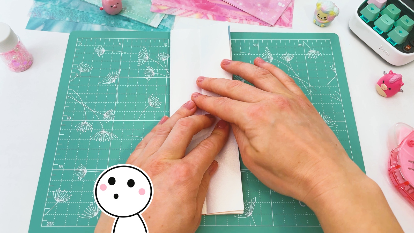 Pressing the paper folded in half into a long narrow strip