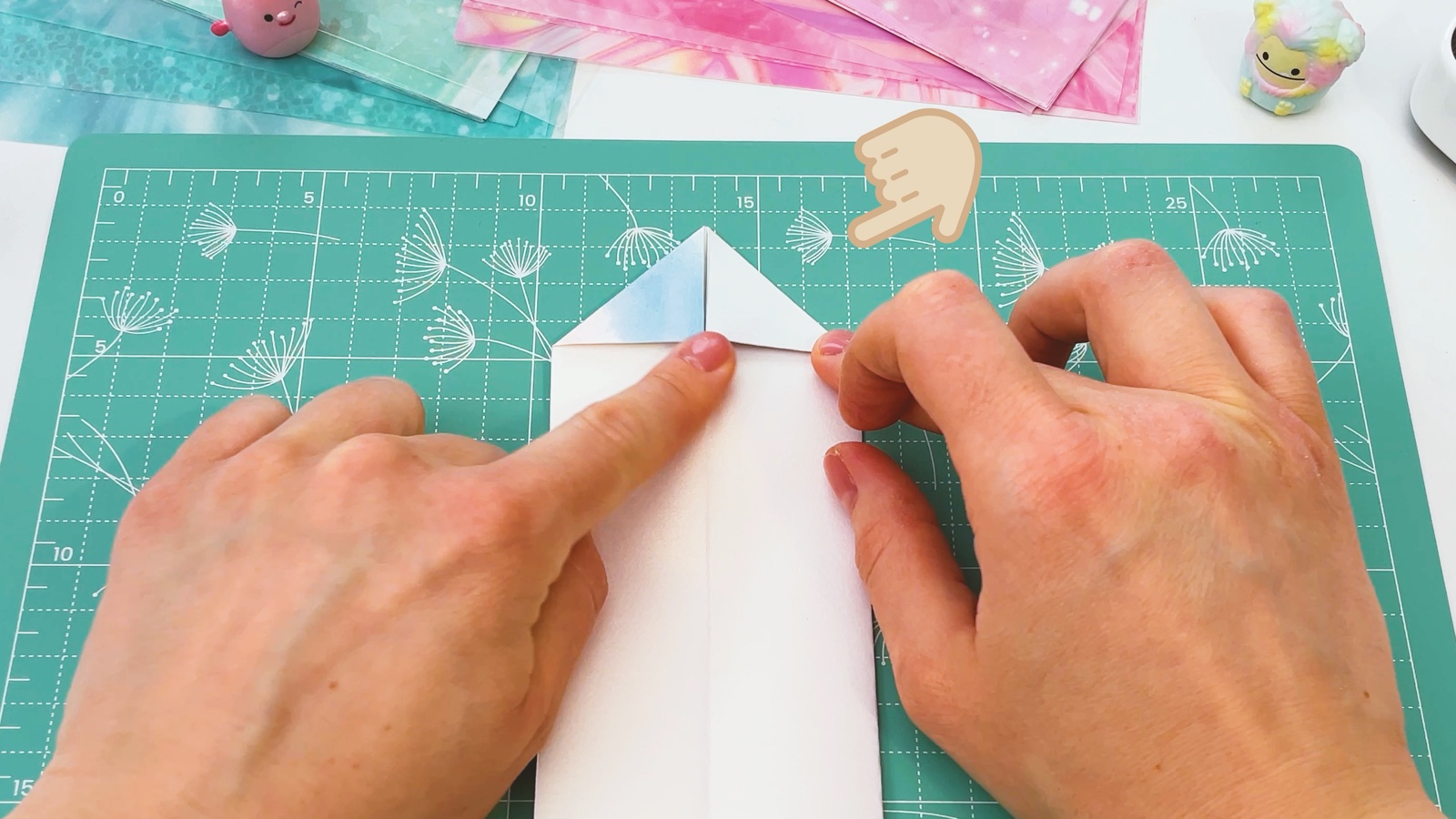 Folding the top corners on the second side into a point