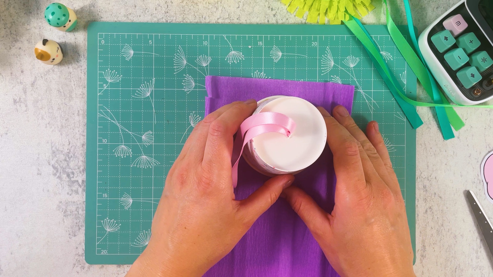 The cup standing upside down on purple crepe paper, ready to trace around its rim