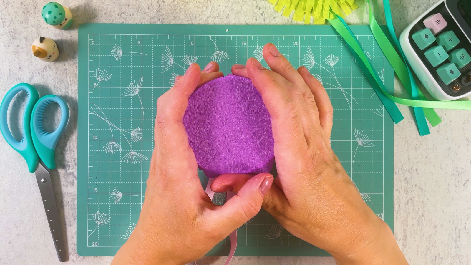 Pressing the purple circle over the open end of the cup