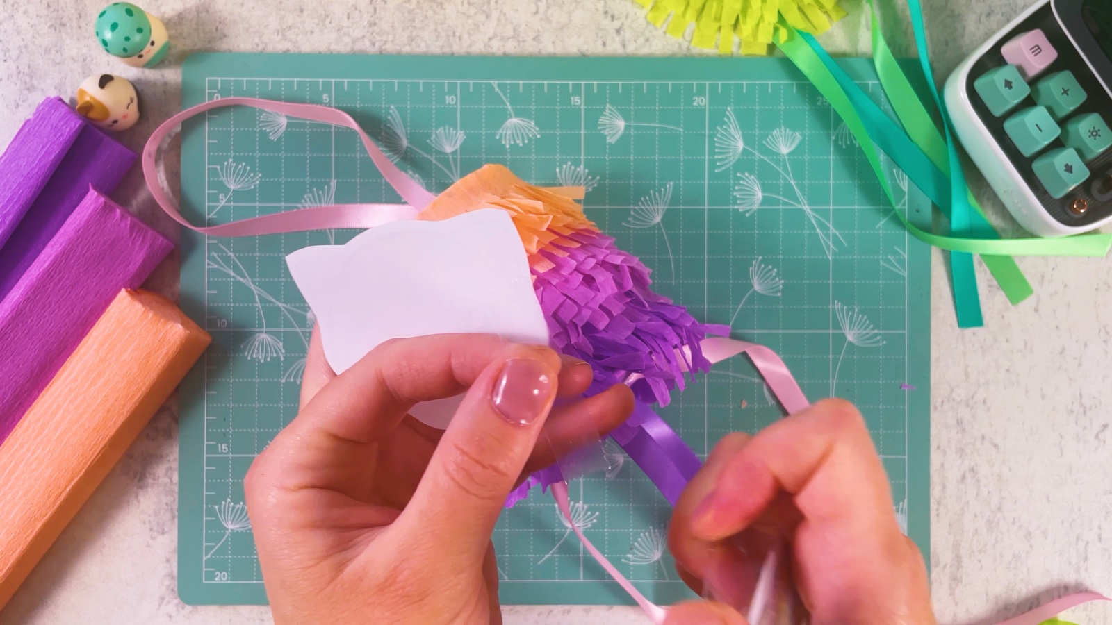 Putting double-sided tape on the back of a printed Pokémon face