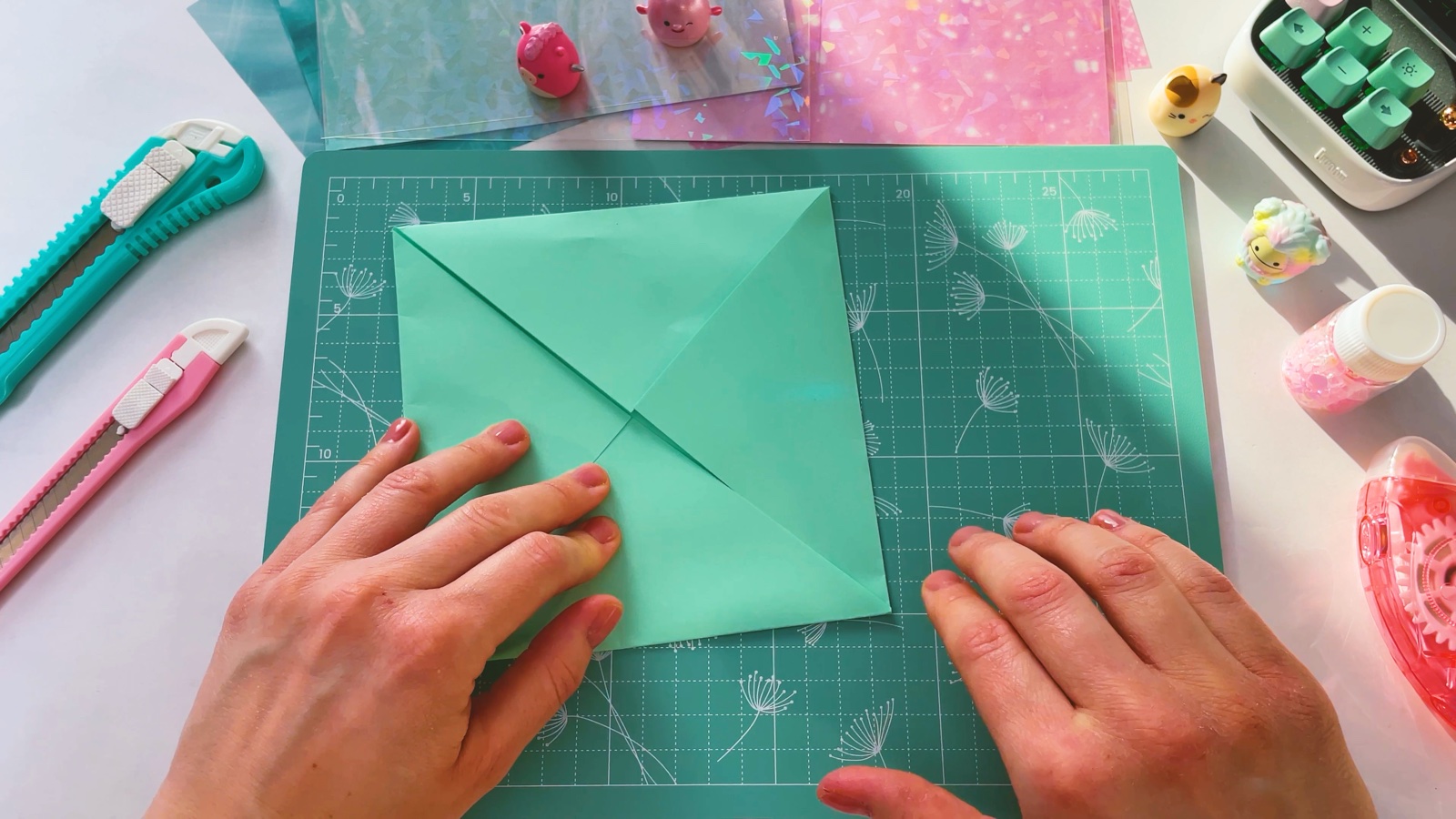 The green square with all four corners folded in to meet in the middle