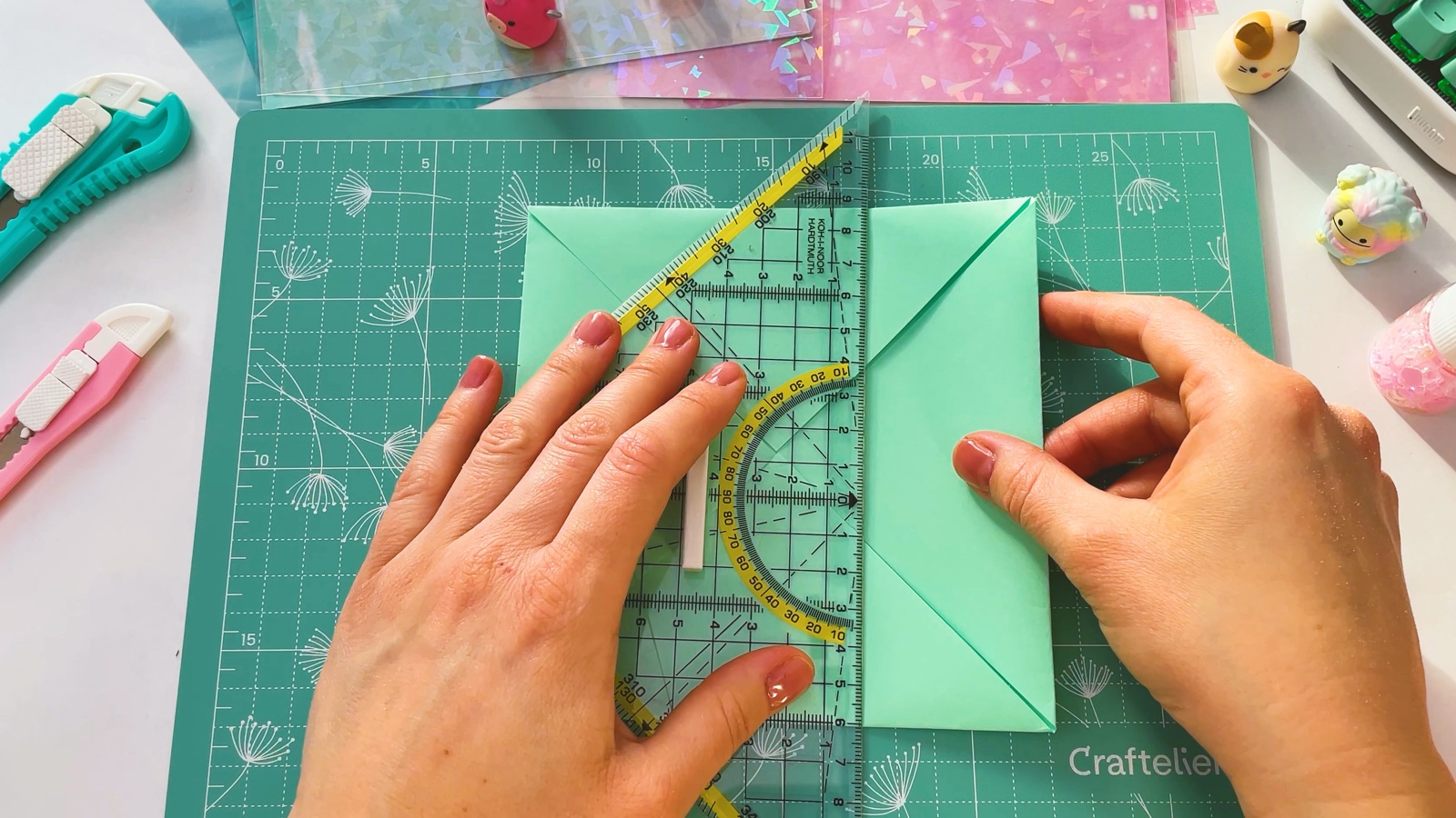 Pressing a ruler along the folded paper while folding the right side in to the middle line