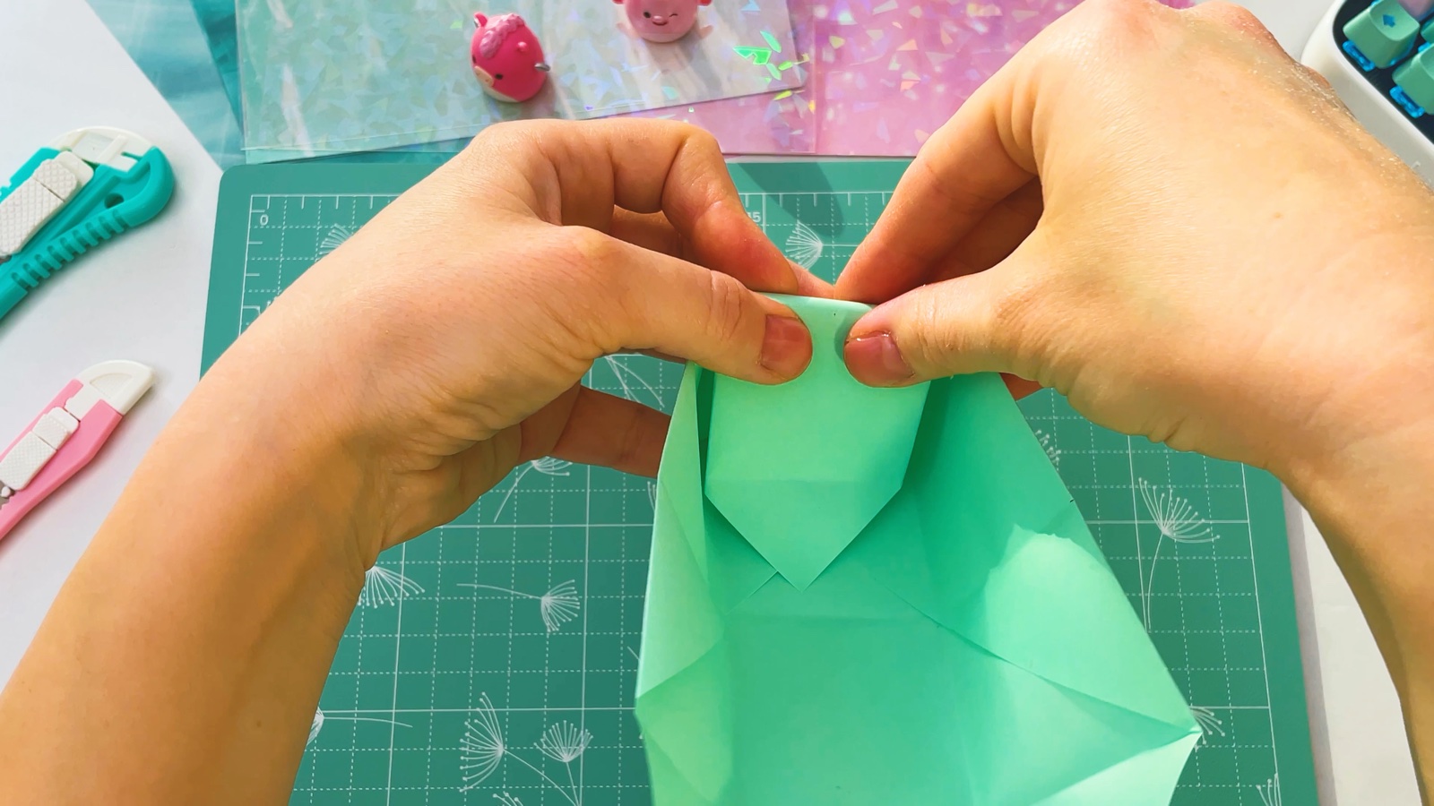 Folding the pointed flap over the end wall and down inside the box