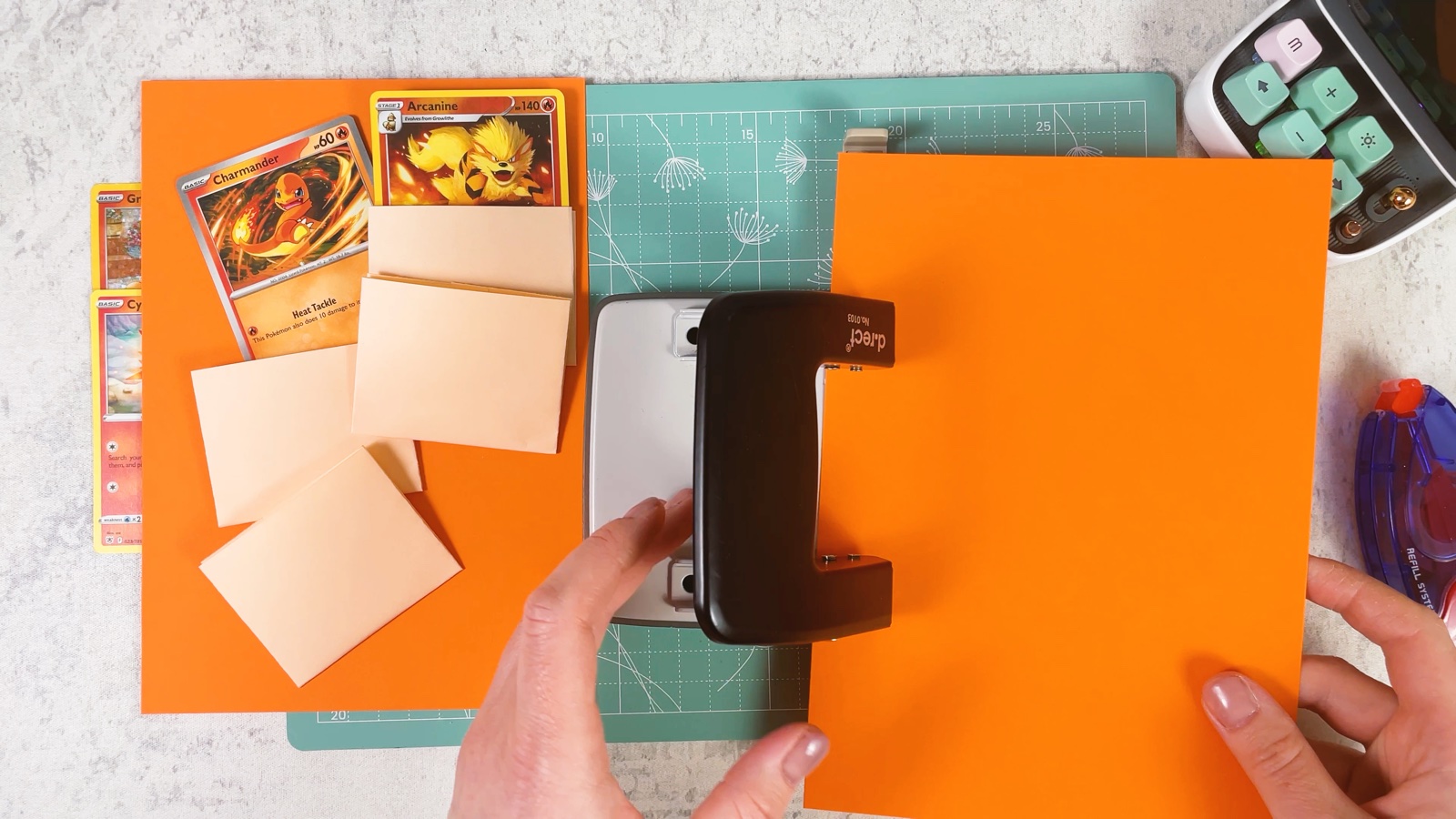 Punching a hole near the left edge of an orange page