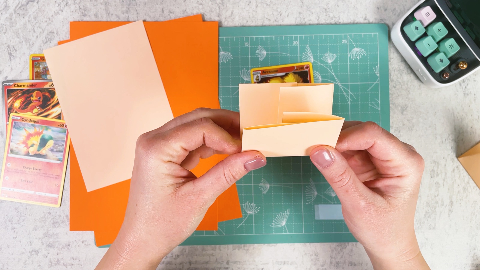 Folding the paper strip in half from the bottom up