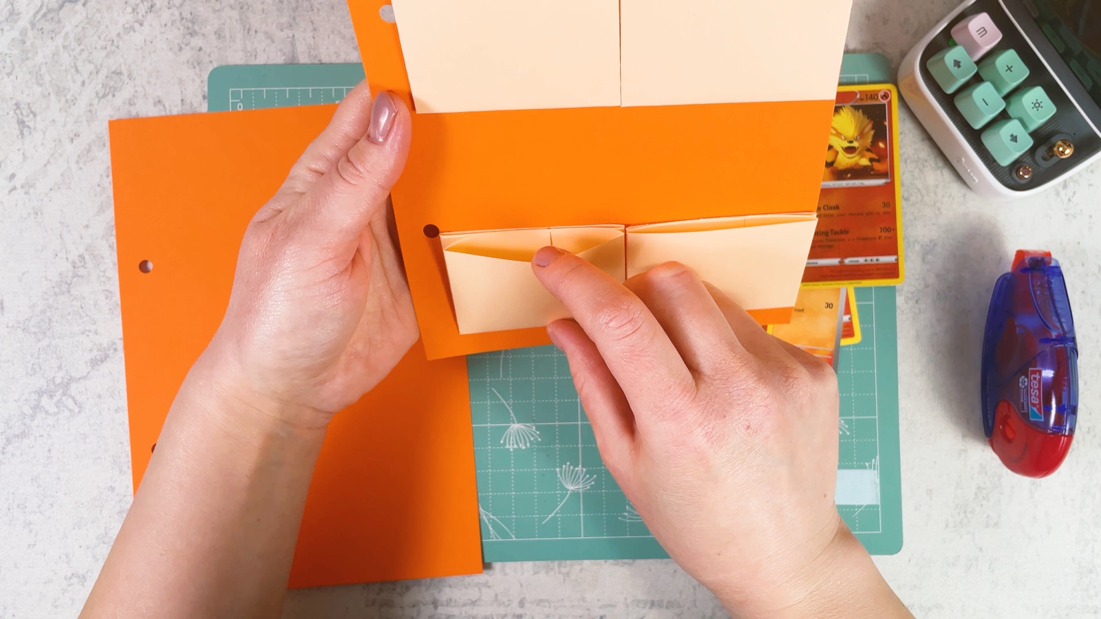 Gluing more pockets onto the back of the orange page