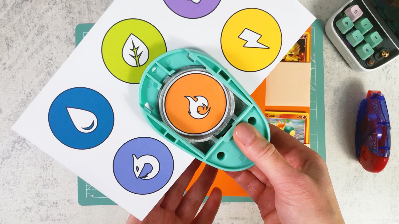 Punching the orange Fire symbol out of a printed sheet of type symbols