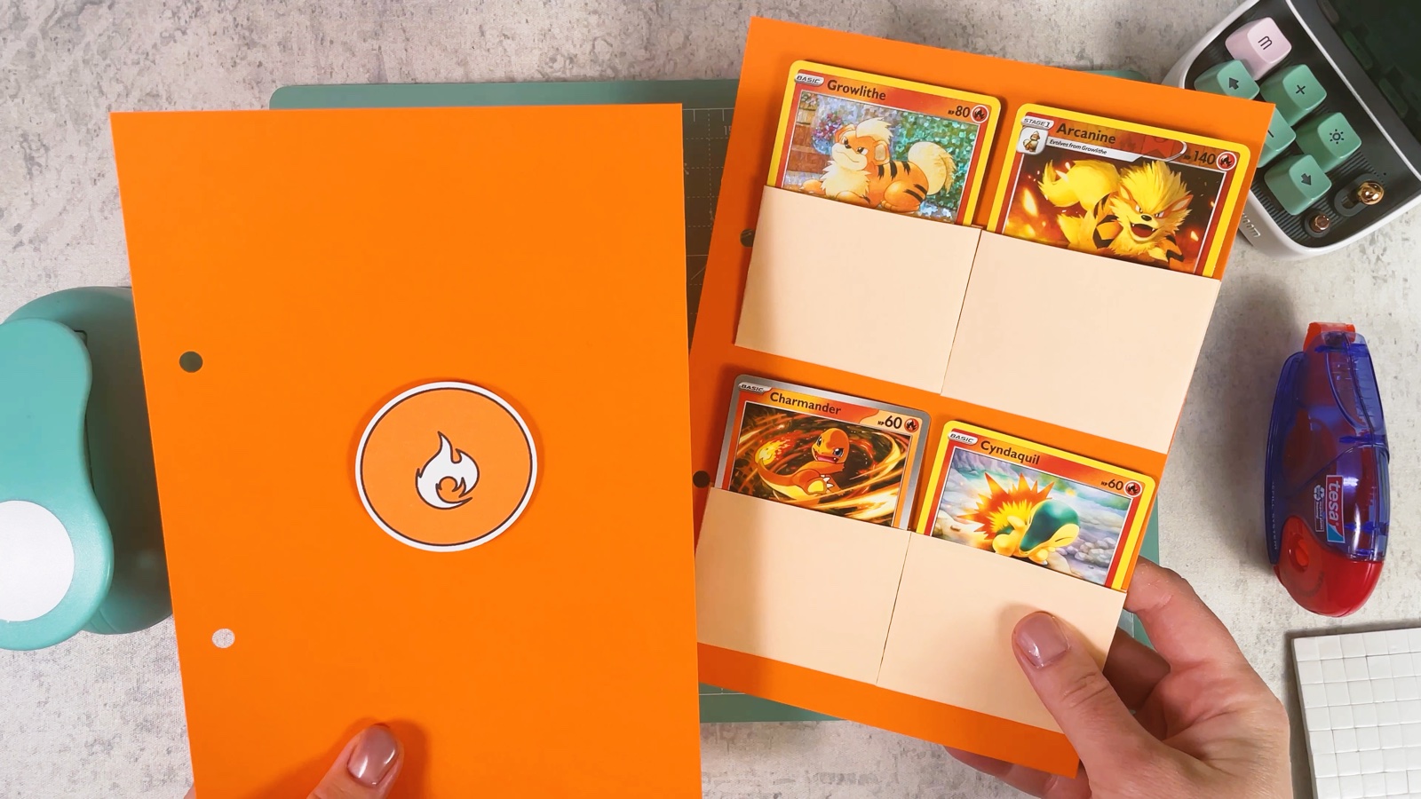 An orange divider page with the Fire symbol, next to a page full of Fire Pokémon cards