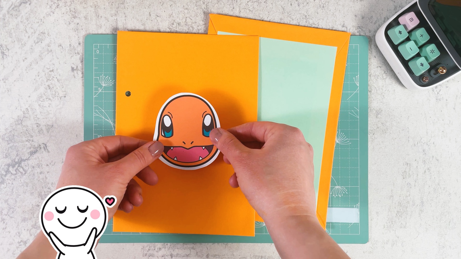 Pressing a Charmander picture onto the orange front cover