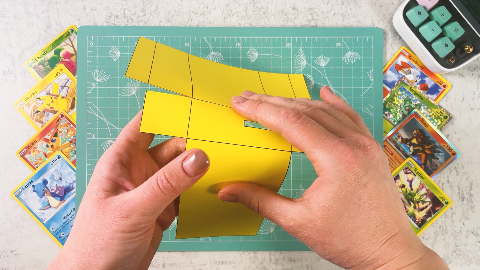 Folding the yellow base along the printed lines