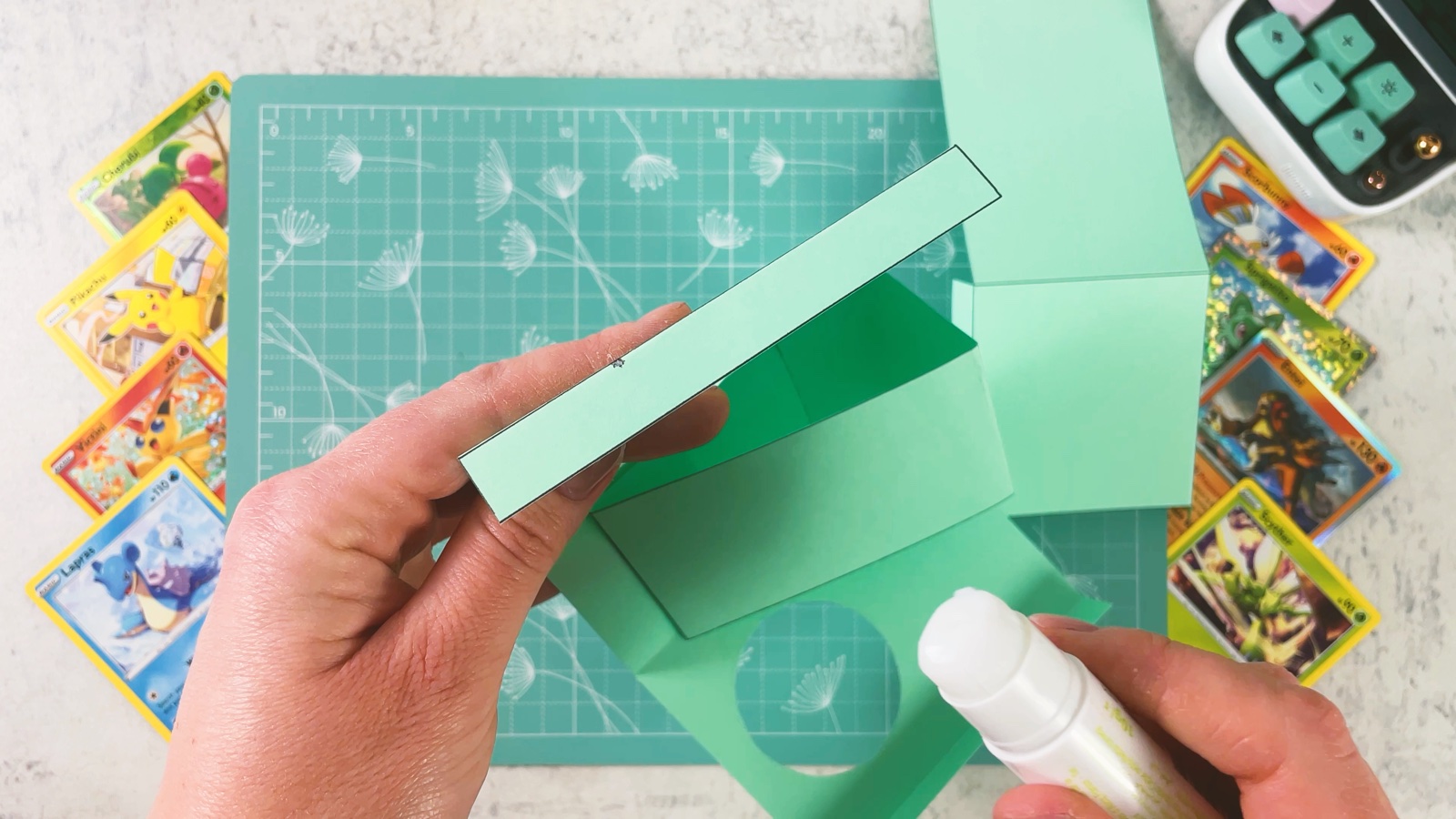 Putting glue on the edge strip of the card tray
