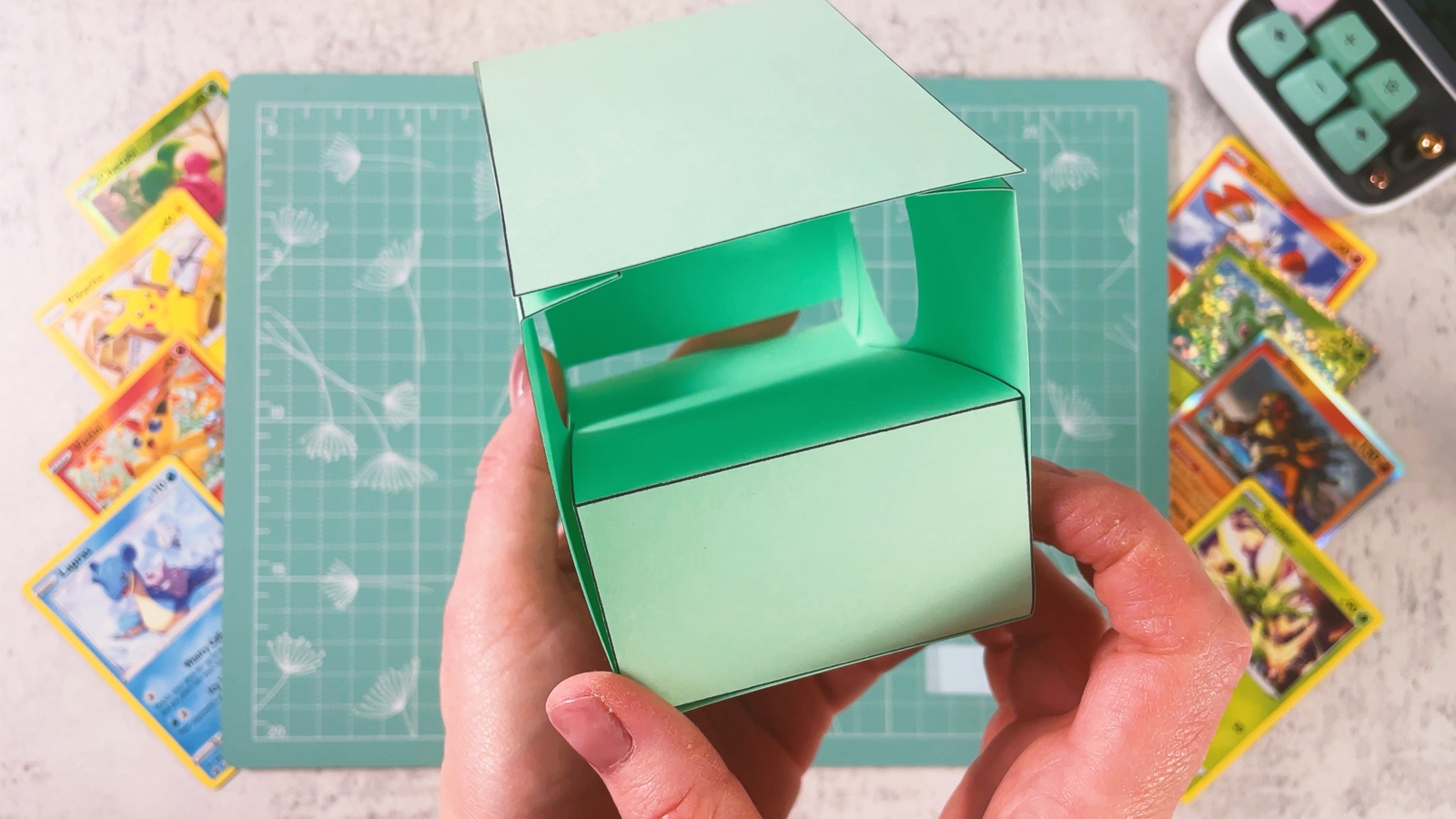 The open mint box from the front, showing the card tray inside and the gap at the bottom