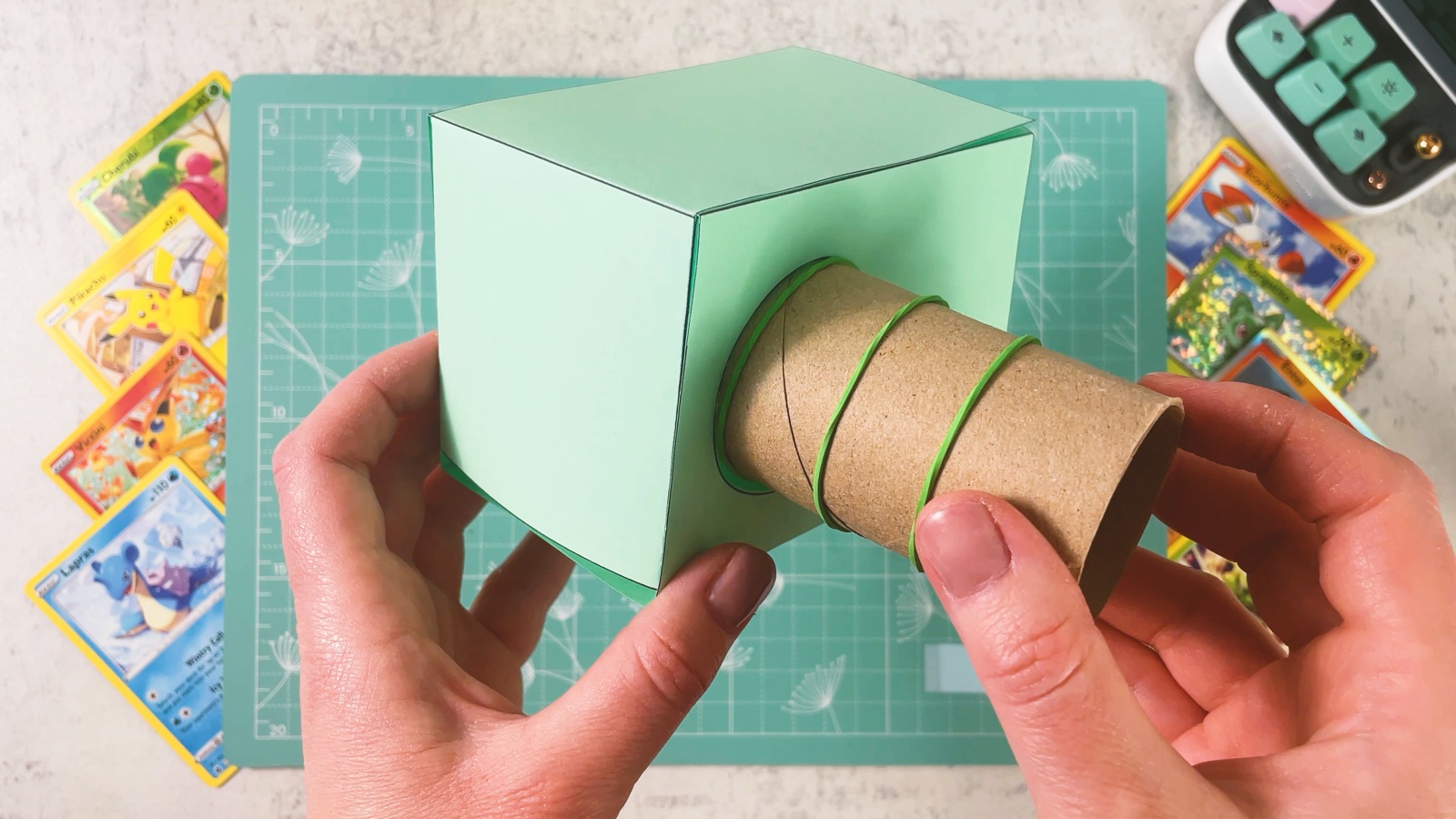 Pushing the cardboard roll through the round holes of the mint box