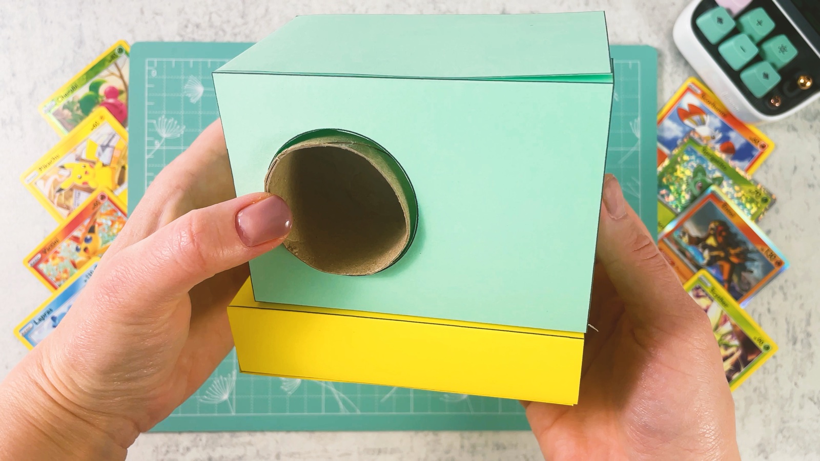 The mint box glued onto the yellow base, with the roller end in the round hole