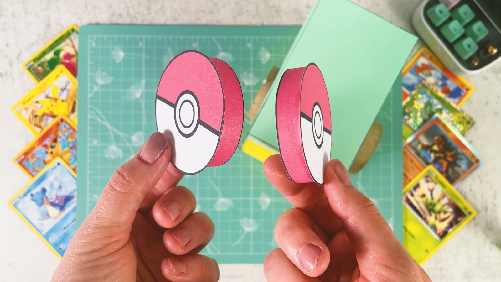 Two finished Poké Ball caps with red rims