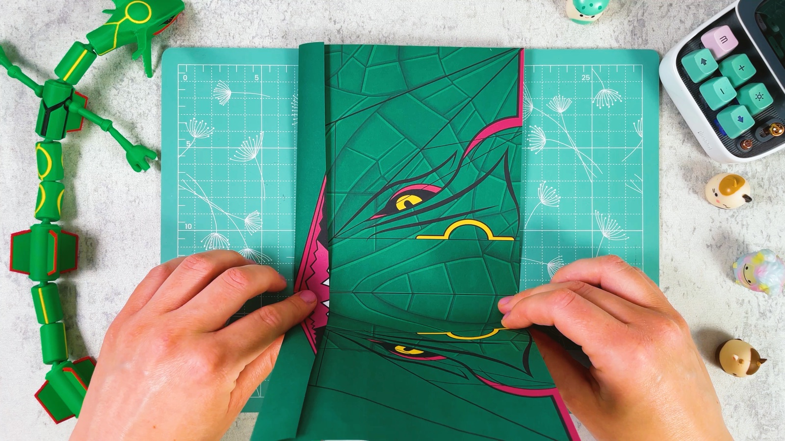 Folding the sheet in half down the middle, between the two eyes