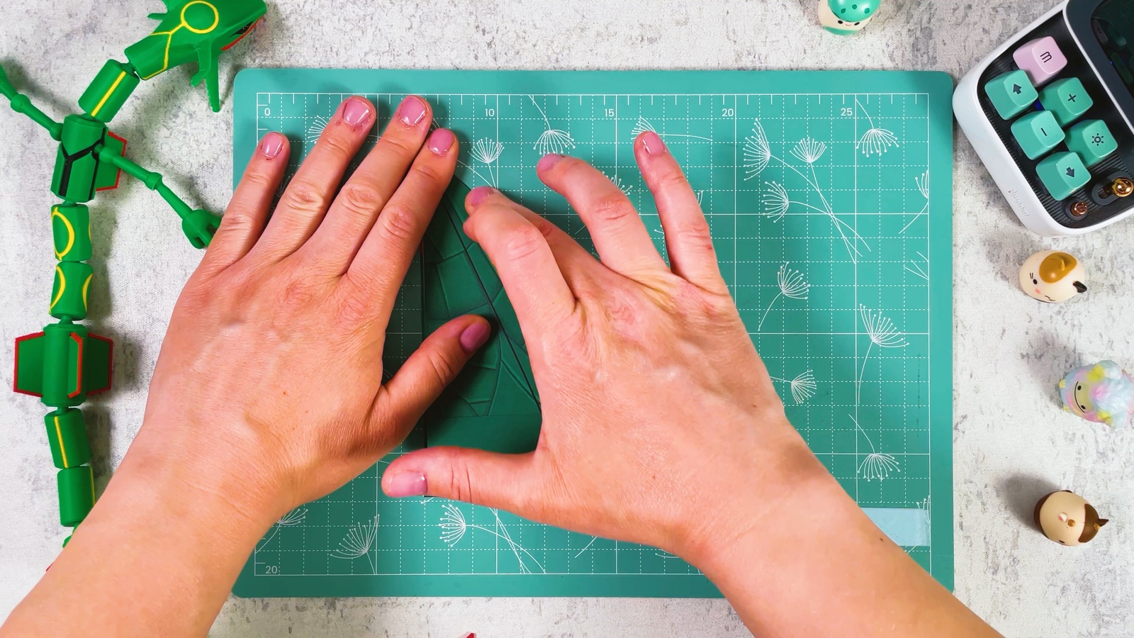 Making the diagonal folds on the other side of the plane, pressing with both hands