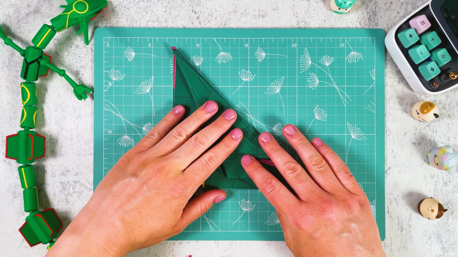 Pressing the first wing flat into a long green triangle