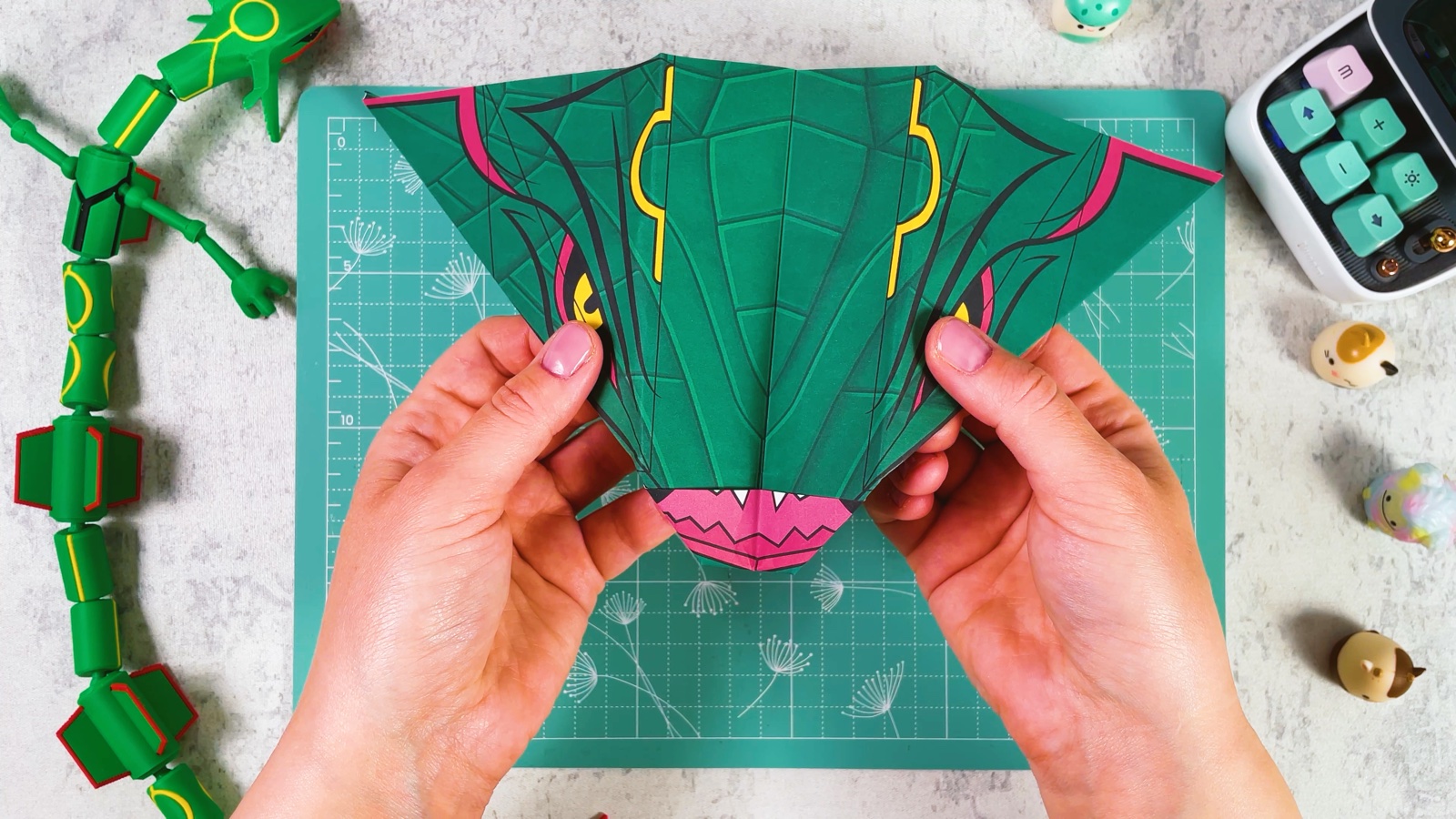 Opening the two wings, with Rayquaza’s pink mouth at the front and yellow markings on top